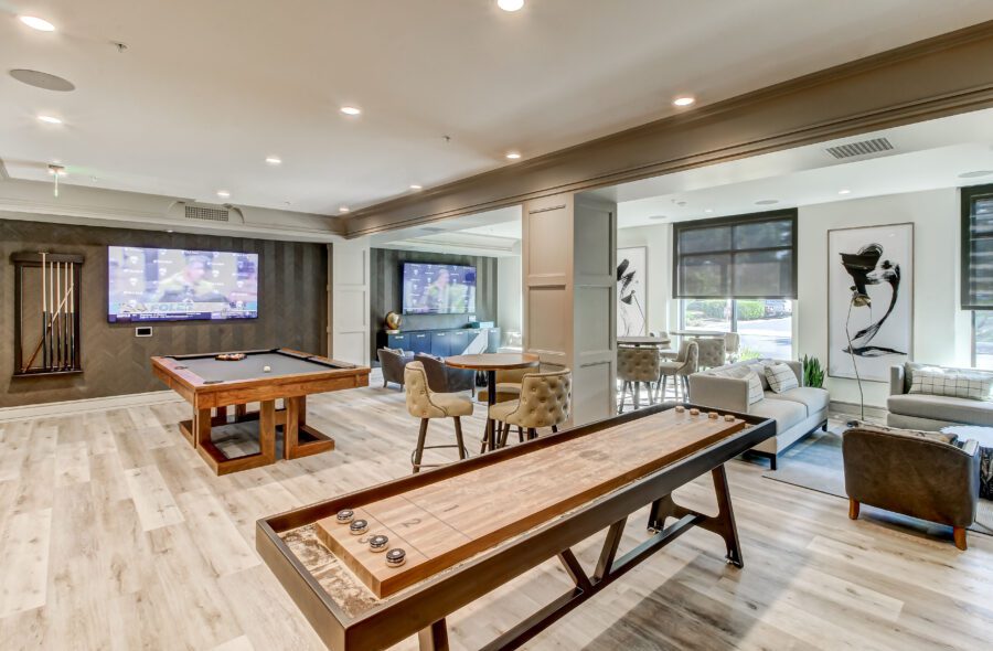 game room area with comfortable seating, large flat-screen TV, pool table, and shuffleboard alternate view 2