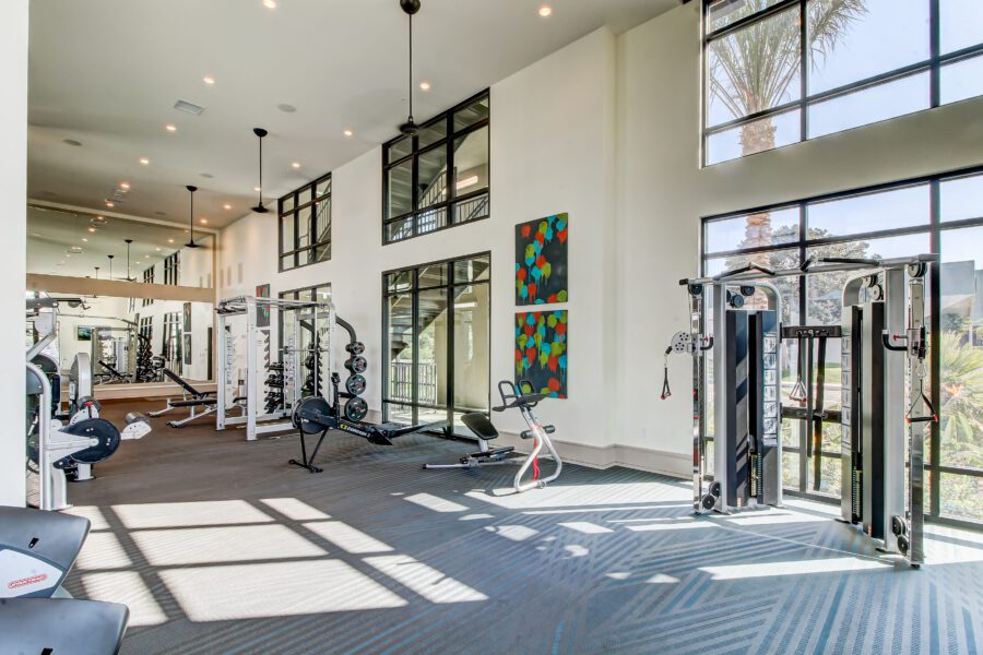 fitness center with strength training equipment, cardio machines, and free weights
